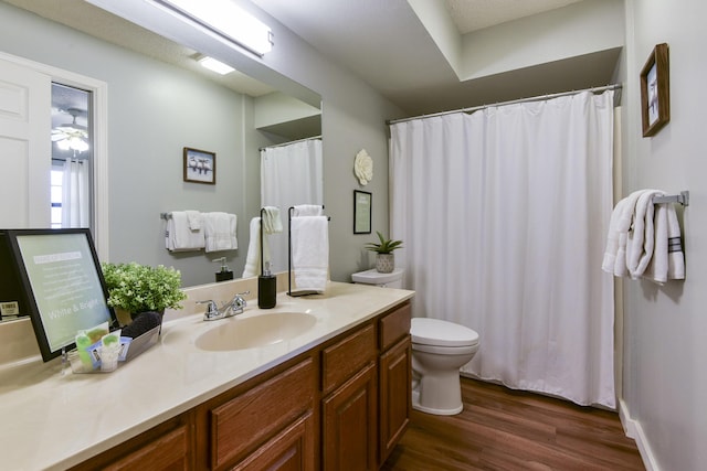 full bathroom with toilet, wood finished floors, and vanity