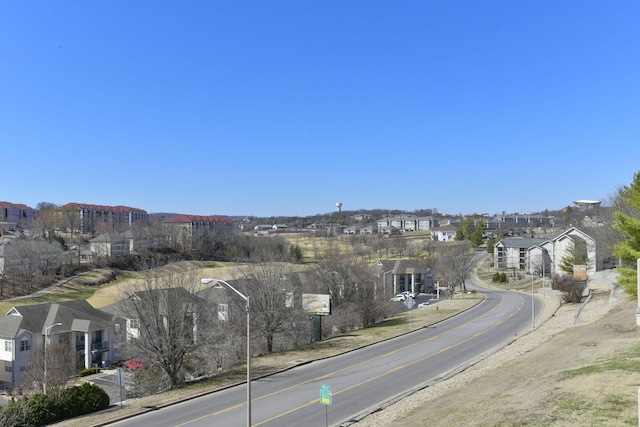 view of road with a residential view and street lights