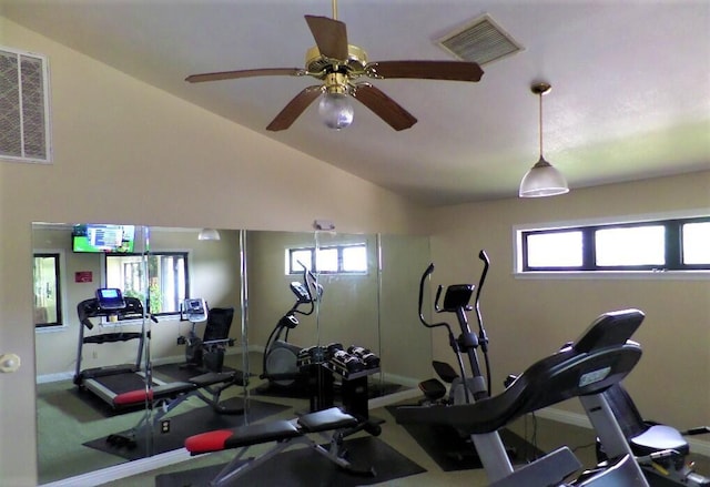 exercise area featuring vaulted ceiling, baseboards, visible vents, and ceiling fan