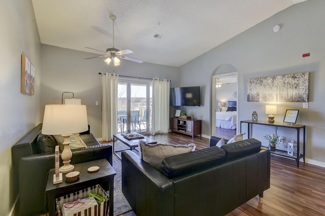 living room with visible vents, lofted ceiling, wood finished floors, and a ceiling fan