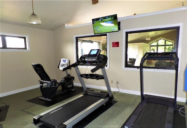 exercise area with baseboards and vaulted ceiling