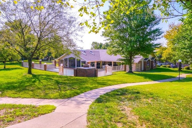 view of front facade with a fenced front yard and a front lawn