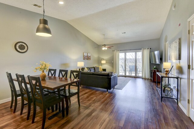 dining space with lofted ceiling, baseboards, visible vents, and dark wood-style flooring