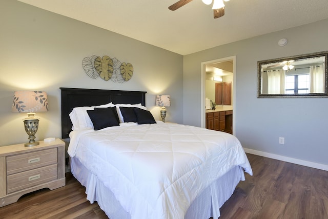 bedroom with dark wood finished floors, ceiling fan, baseboards, and connected bathroom