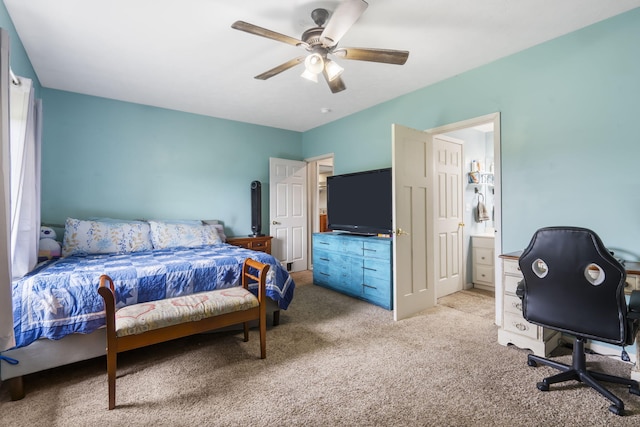 bedroom featuring carpet flooring, ensuite bath, and a ceiling fan