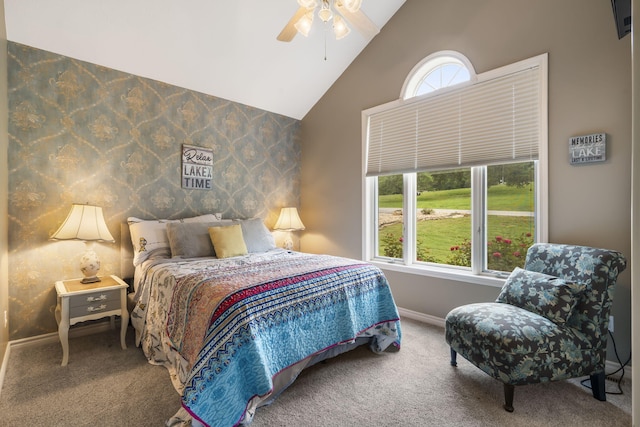 carpeted bedroom featuring high vaulted ceiling, wallpapered walls, baseboards, and a ceiling fan