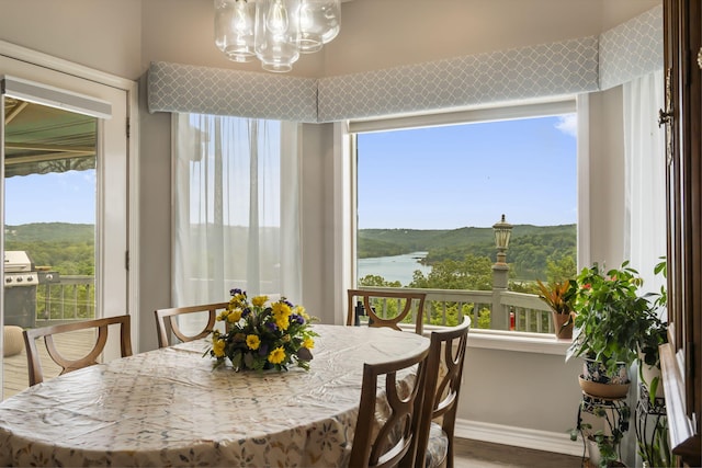 dining area featuring an inviting chandelier, baseboards, and a wealth of natural light