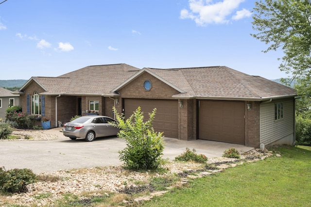 single story home with a garage, brick siding, driveway, and roof with shingles