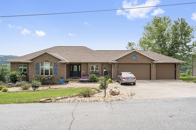 single story home with brick siding, driveway, a shingled roof, and a garage