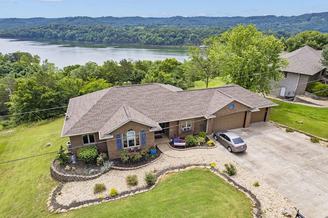 aerial view featuring a forest view and a water view