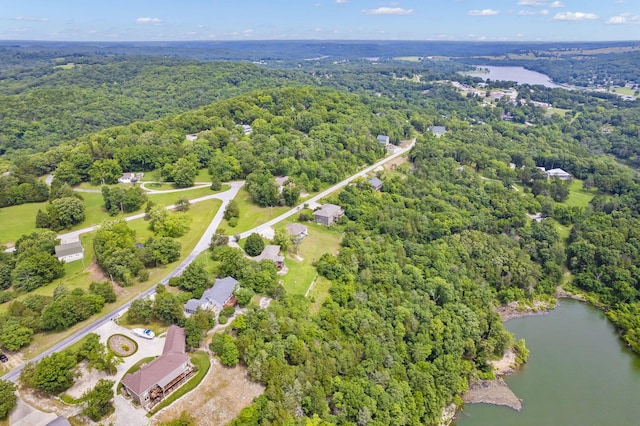 bird's eye view with a forest view and a water view