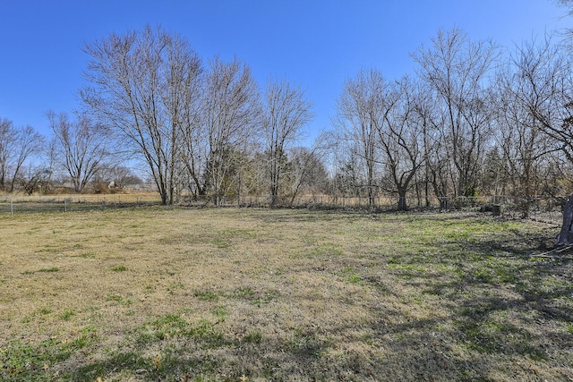 view of yard with a rural view and fence