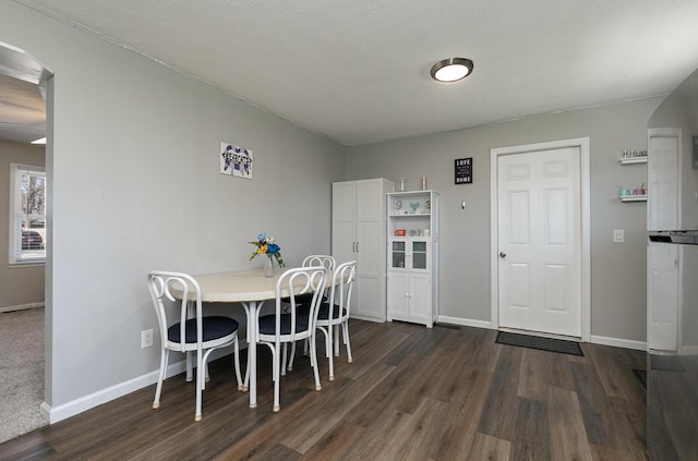 dining room with dark wood-style floors and baseboards