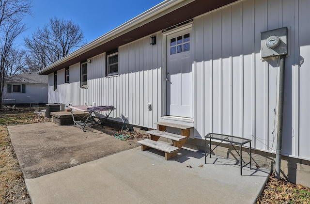 property entrance with a patio area and central AC unit