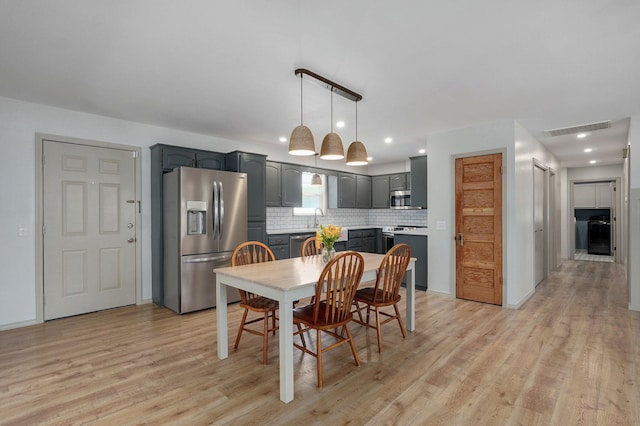 dining space with recessed lighting, light wood-style floors, and visible vents