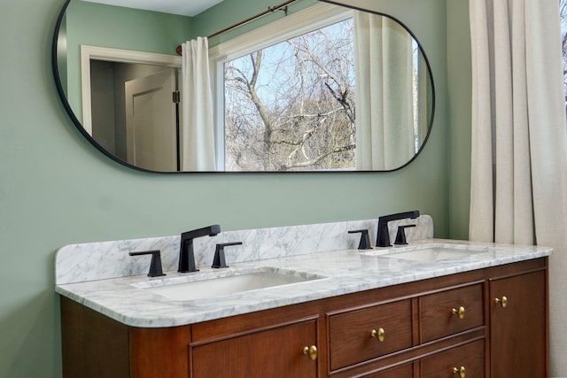 bathroom with a sink and double vanity