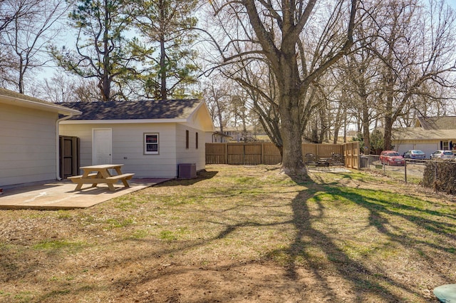 view of yard with a patio area, central air condition unit, and a fenced backyard