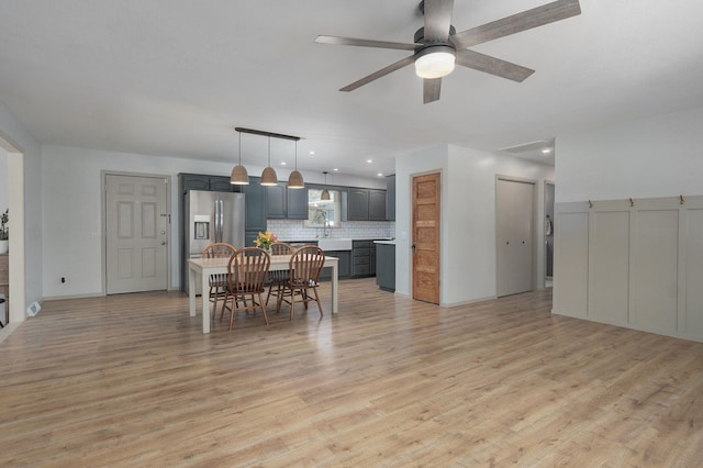 dining space featuring light wood-style floors and a ceiling fan