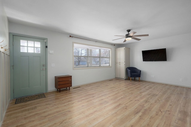 foyer with light wood finished floors and ceiling fan