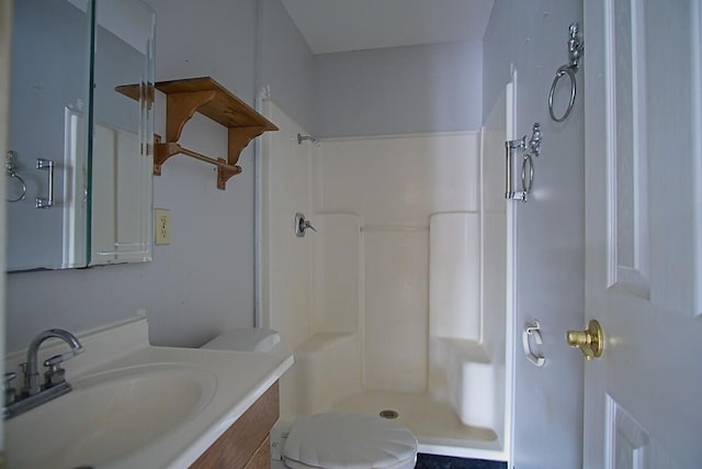 bathroom with vanity, toilet, and walk in shower