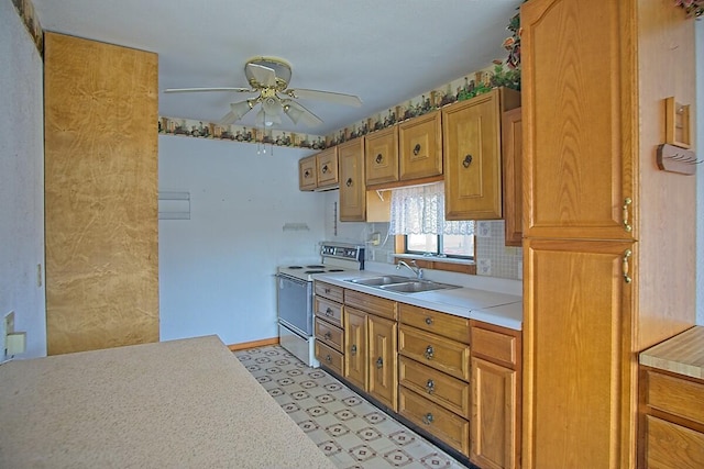 kitchen with a ceiling fan, light floors, a sink, light countertops, and white range with electric stovetop