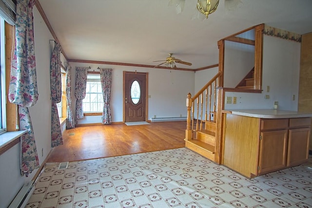 entryway featuring light wood finished floors, crown molding, a baseboard heating unit, baseboards, and stairway