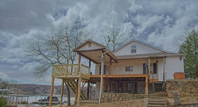 back of house featuring stairs and a water view