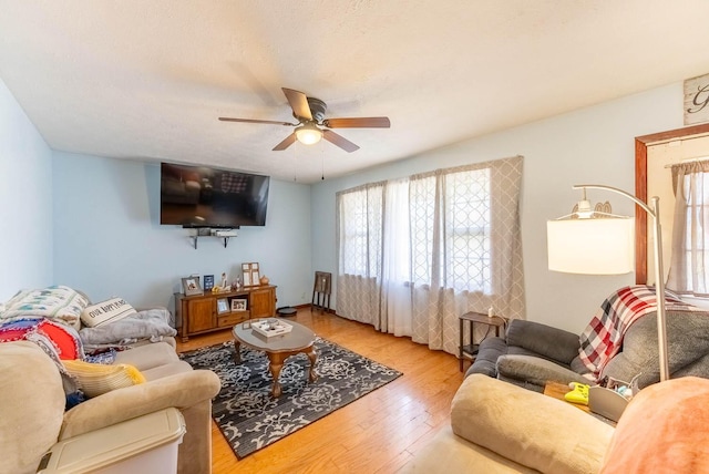 living room with ceiling fan and hardwood / wood-style floors