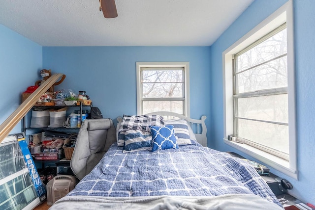 bedroom featuring a ceiling fan and a textured ceiling