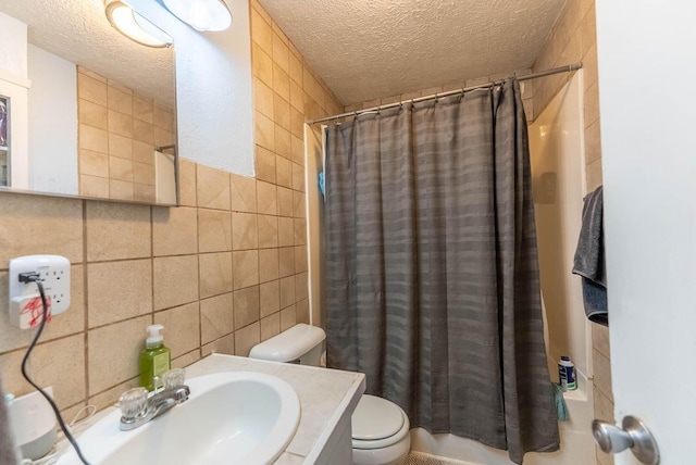 bathroom with a textured ceiling, toilet, tile walls, and a shower with curtain