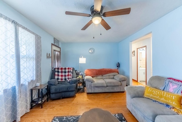 living area featuring a ceiling fan and light wood-style floors