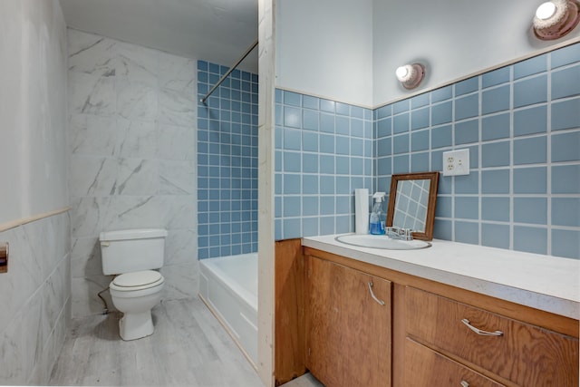 bathroom featuring toilet, shower / tub combination, vanity, wood finished floors, and tile walls