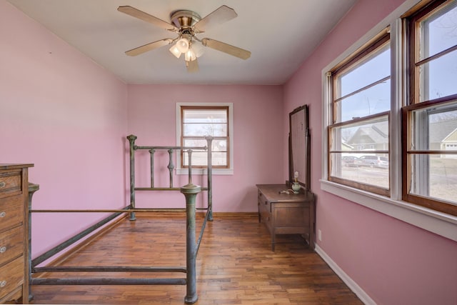 bedroom featuring baseboards and wood finished floors