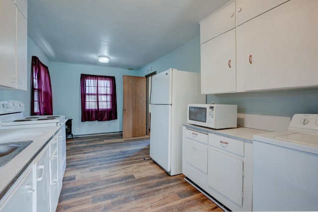 kitchen with washer / clothes dryer, wood finished floors, white cabinetry, white appliances, and light countertops