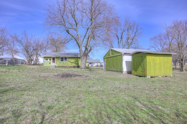 view of yard featuring an outbuilding and a storage shed