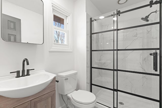 full bathroom with vanity, toilet, and a shower stall