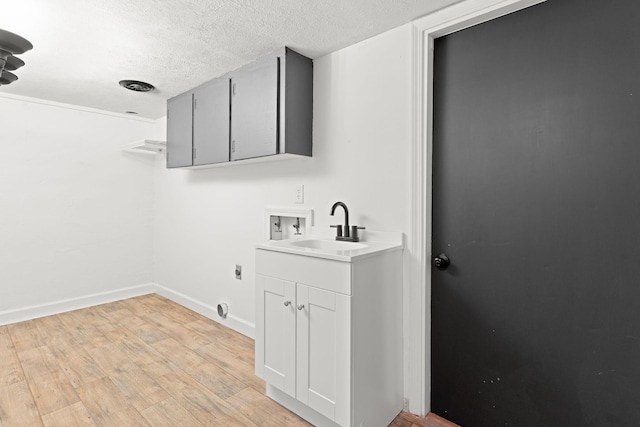 bathroom featuring vanity, wood finished floors, baseboards, and a textured ceiling