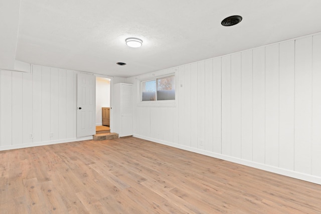 unfurnished room featuring light wood-type flooring and baseboards