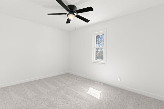 spare room featuring visible vents, baseboards, a ceiling fan, and carpet flooring