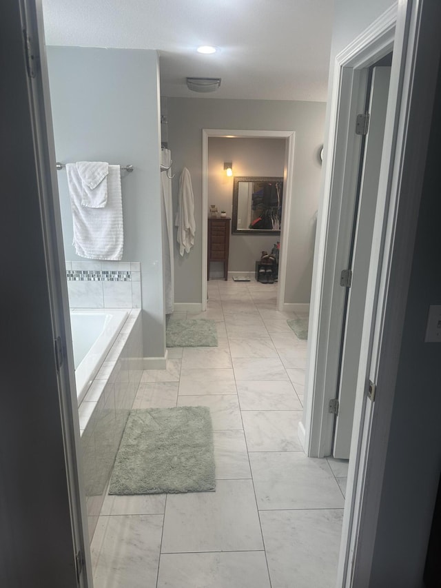 hall with marble finish floor and baseboards