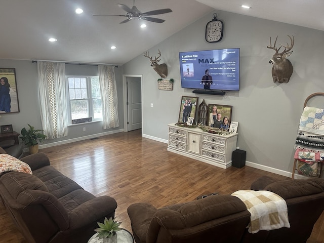 living room with baseboards, wood finished floors, a ceiling fan, and vaulted ceiling