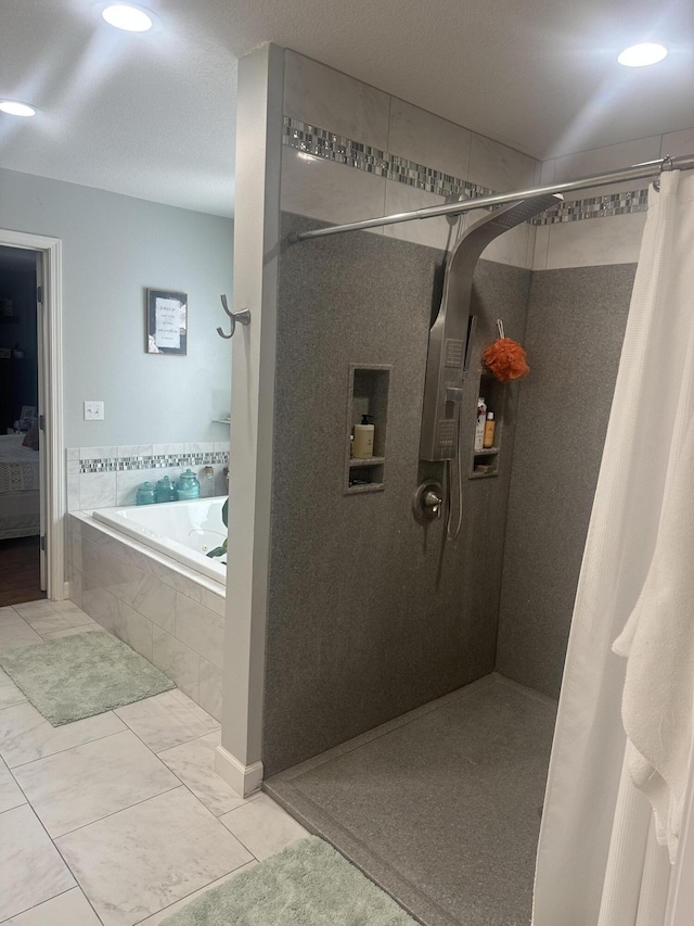 full bathroom with a tile shower, ensuite bathroom, and a garden tub