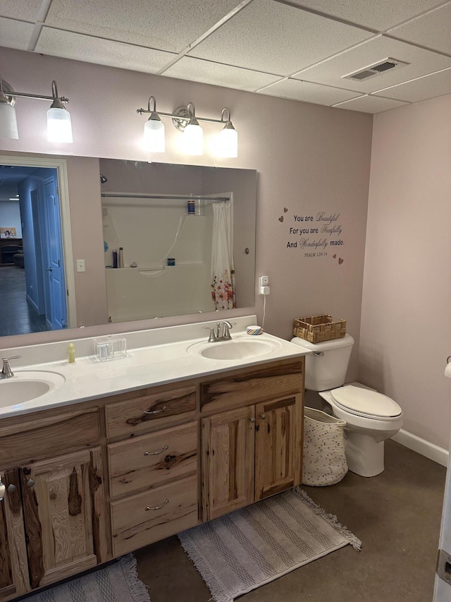 full bath with a sink, visible vents, toilet, and a drop ceiling