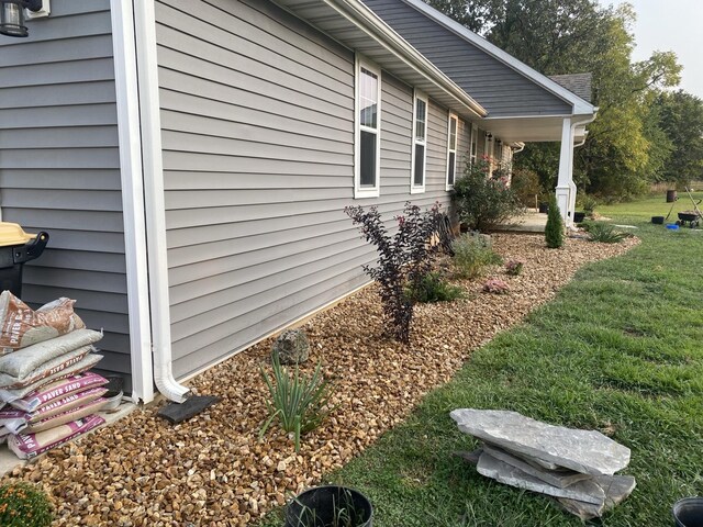 view of home's exterior with a lawn