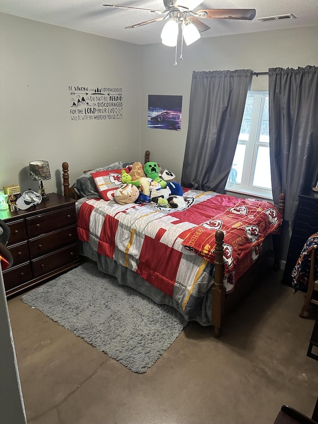 bedroom featuring visible vents, a textured ceiling, concrete flooring, and ceiling fan