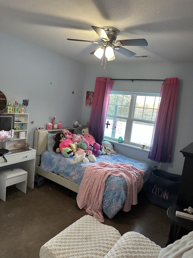 bedroom featuring visible vents, carpet flooring, a textured ceiling, and ceiling fan