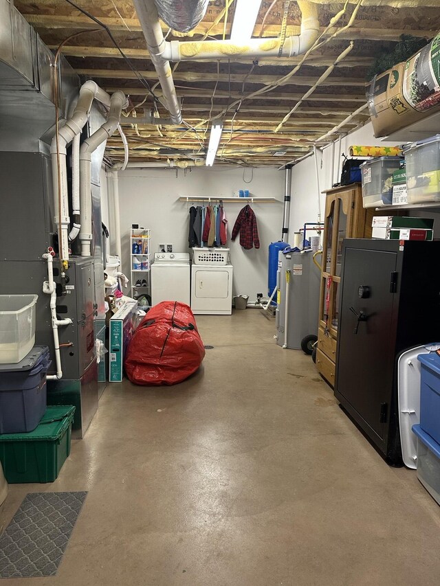 unfinished basement with washing machine and clothes dryer and heating unit