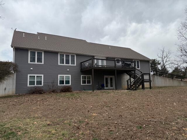 back of property featuring stairway, french doors, and a deck