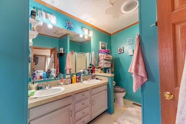 bathroom featuring tile patterned flooring, ornamental molding, toilet, and a sink