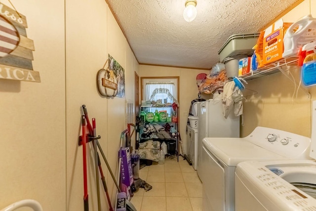 laundry area with a textured ceiling, independent washer and dryer, light tile patterned flooring, and laundry area